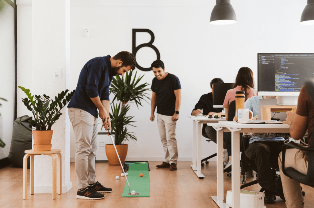 Staff playing mini golf at Brief Creatives Office